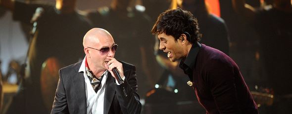 Latin music star Enrique Iglesias singing with Latin rap star Pitbull.