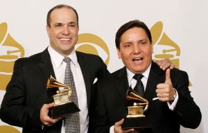 Spanish Harlem Orchestra director Oscar Hernandez holding Grammy award with Marco Bermudez.
